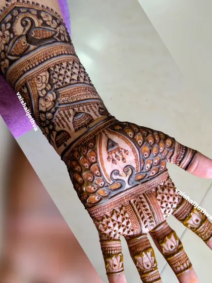 A heavy and intricate design perfect for bridesmaids. This mehndi is filled with peacocks, jhumkas, and detailed patterns to complement the bridal party's look.