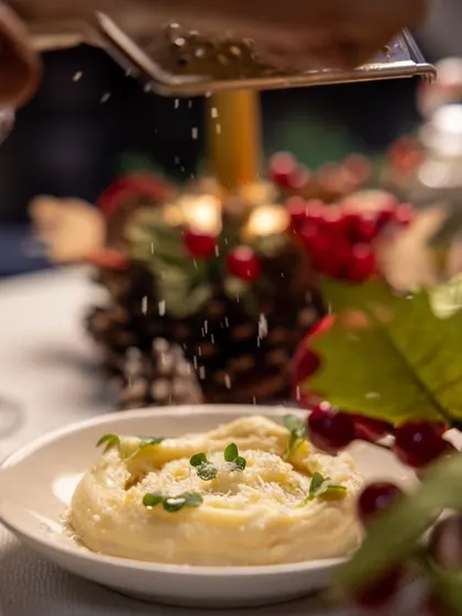 The motion of grating fresh parmesan over a dish captures the freshness and quality of the ingredients we use in our festive meals.