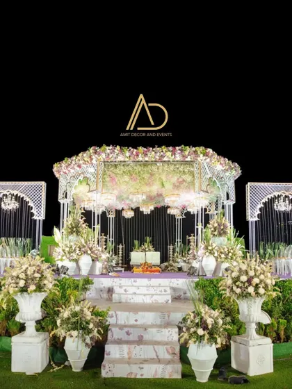 A full view of a one of a kind wedding stage, featuring a purple carpet, delicate florals, and elegant chandeliers, creating a unique and luxurious atmosphere.