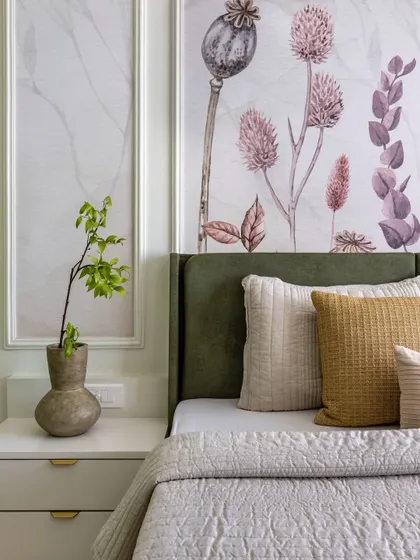 A detail shot of the sage green headboard and custom wallpaper, showcasing the subtle sophistication and natural elements that define this master bedroom.