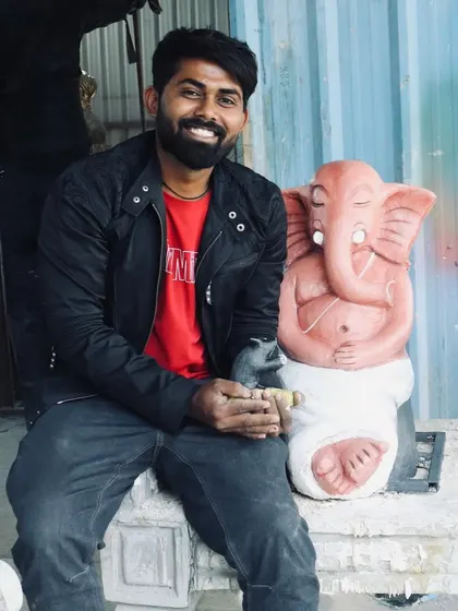 Another photo of me with the finished meditative Ganesha sculpture. This angle shows the calm expression and the small details that give the idol its personality and spiritual feel.