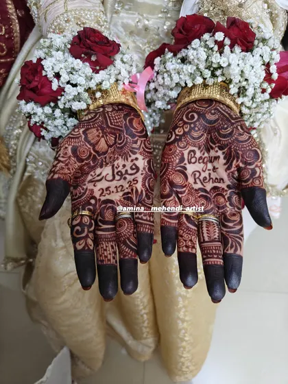 I love weaving your story into the mehendi. This design features the phrase 'Qubool Hai' and the wedding date, making it a beautiful and personal memory of the special day.
