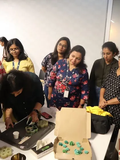 Our instructor provides a demonstration to a group at the HBC office, showing them how to work with cactus-shaped wax molds for their candles.