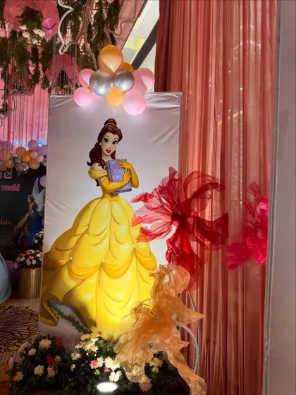 A beautiful standee of Princess Belle from "Beauty and the Beast" used as part of the decor for a baby welcome event.