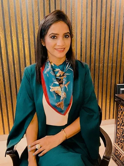 This is how I style myself for an important professional meeting. The structured green blazer paired with a complementary printed scarf creates a look that is both authoritative and approachable, ensuring you make a memorable first impression.