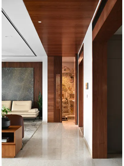 With the doors open, the intricately carved traditional temple is revealed, creating a stunning contrast with the modern lines of the corridor.