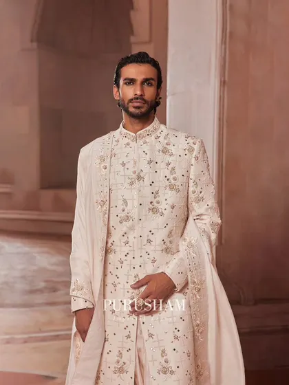 This ensemble from the 'Takht' collection is about excellence. The intricate embroidery on the sherwani and the matching stole create a cohesive look that is nothing short of regal.
