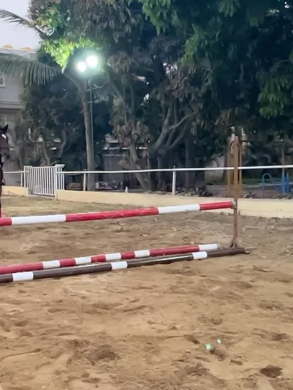 A rider and horse approach a jump during a training camp. The focus and preparation in these moments are just as important as the jump itself.