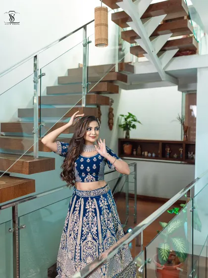 A playful and candid moment captured in the stunning blue bridal lehenga. The outfit allows for easy movement while looking absolutely grand.