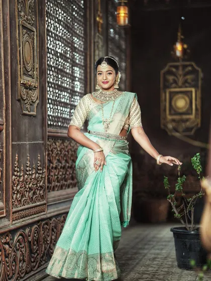 The subtle sheen of the silk and the delicate silver zari work make this saree a unique and elegant choice.