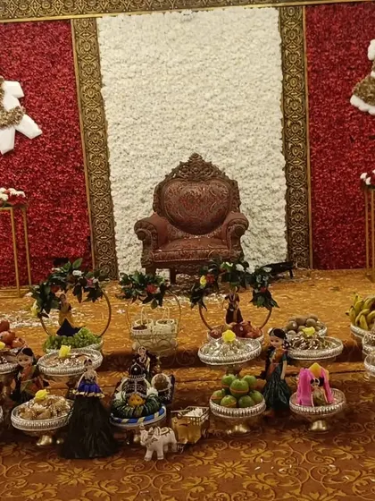This baby shower platter setup was done at Liverpool Hotels. The display features cute elements like baby clothes made of flowers on the backdrop, coordinated with the platters below.