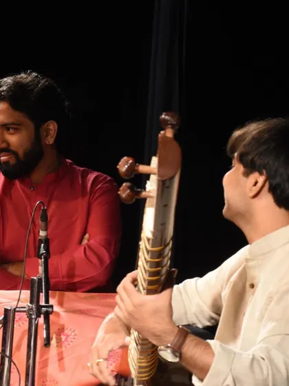 Interacting with my tabla accompanist during the Malhardhara concert. This non-verbal communication is key to our performance.