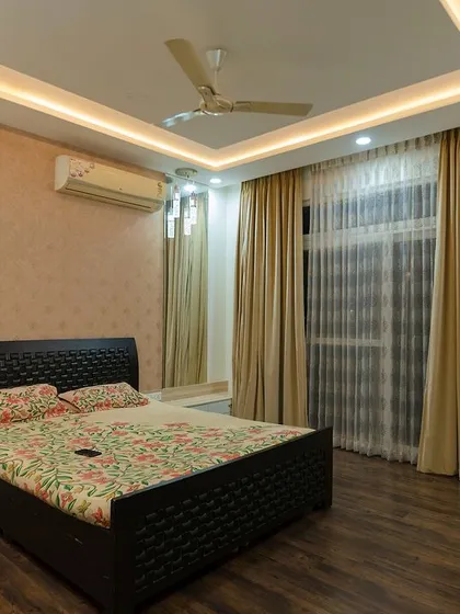 The same master bedroom, showing the simple yet stylish nightstands and the soft, ambient lighting that creates a relaxing mood.