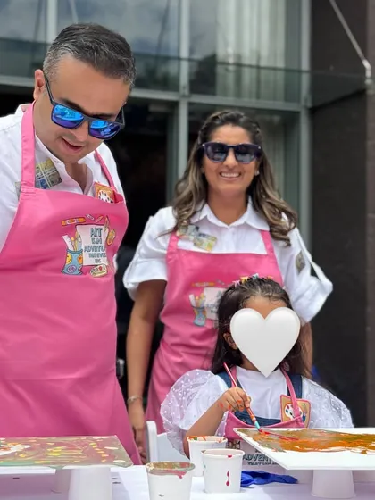 A family having a blast at a fluid art birthday party. It's a great activity for all ages, allowing everyone to get creative and a little messy.
