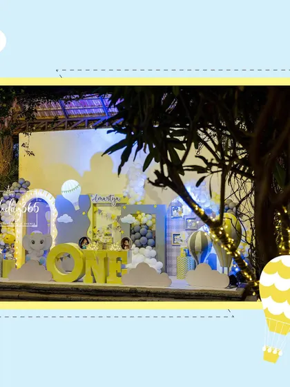 A wide shot of the hot air balloon and elephant-themed party, showing the full stage setup.