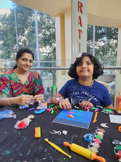 A mother and daughter deeply engaged in their clay art. The concentration and creativity in this photo capture the essence of our hands-on workshops.