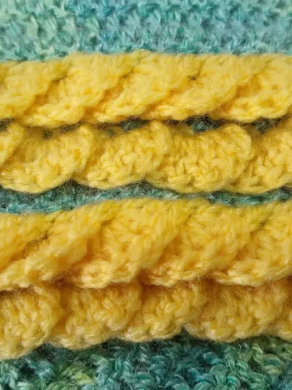 A macro shot of the "lemon frosting" edging on my semi-circle shawl. This textured border is created with a series of shell stitches, adding a decorative and sturdy finish.