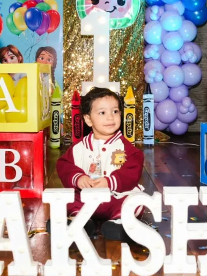 A cute portrait of the birthday boy surrounded by colorful alphabet blocks.
