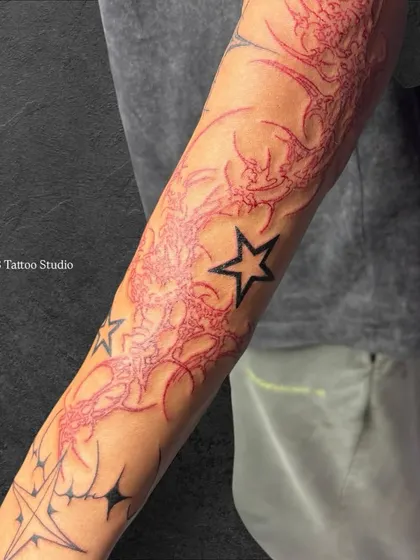 A close-up look at the intricate red linework in the neo-tribal sleeve.
