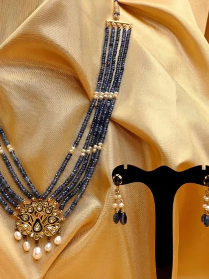 The complete peacock pendant set, with the necklace and earrings displayed together, offering a full view of this exquisite Kundan and sapphire collection.