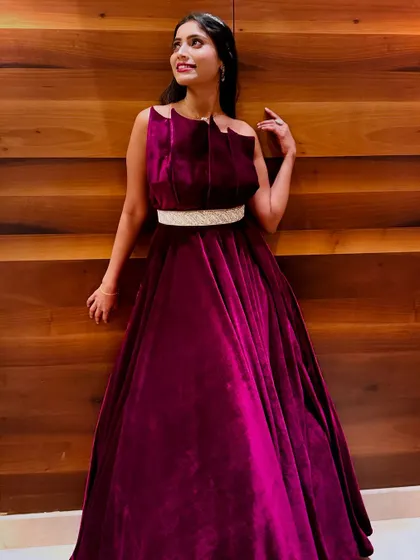 A candid, happy moment in the magenta velvet gown. This shows the comfort and joy of wearing an outfit that makes you feel beautiful.