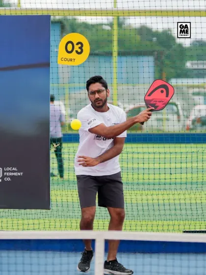 A competitor executes a clean forehand volley during the tournament. Every point is a battle for position and control.