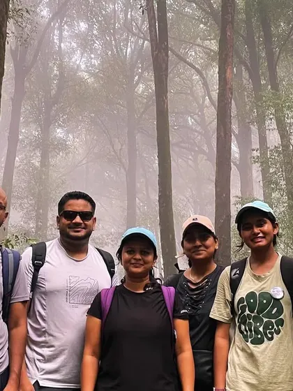 Trekking through the misty forests of the Western Ghats on the way to Kurinjal Peak. The dense shola forests create a magical and immersive experience.