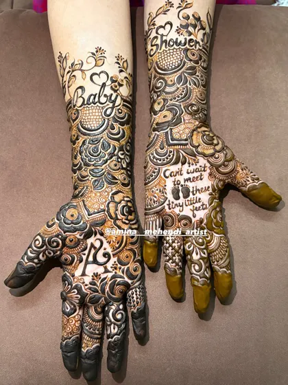 Another angle of the fresh baby shower mehendi, highlighting the delicate vines on the forearm and the personalized details on the palms.