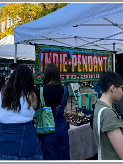 My hand-painted banner for 'Indie-Pendant' on display at an outdoor market stall. My signs are designed to be eye-catching and draw customers in.