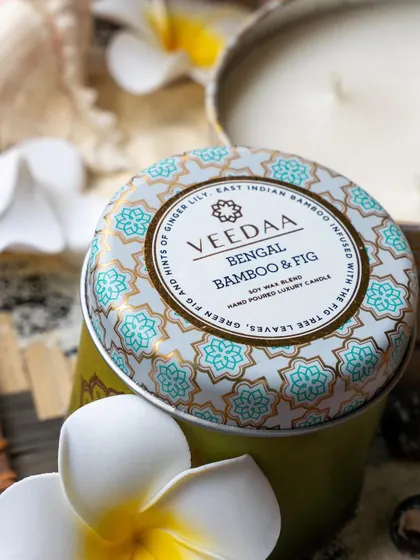 A close-up of our Bengal Bamboo & Fig tin candle, a fragrance that transports you to a summer paradise. The intricate design on the tin is as delightful as the scent inside.