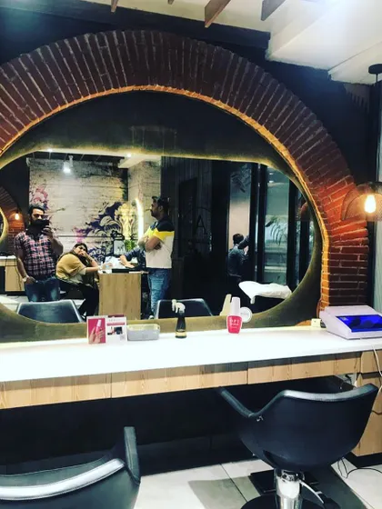 This salon features a rustic brick arch around the mirror, giving it an industrial-chic vibe. It shows how I can work with different materials to create a unique look that matches the salon's brand.