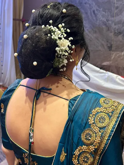 A beautiful bun created for the mother of the bride, decorated with pearls and baby's breath.