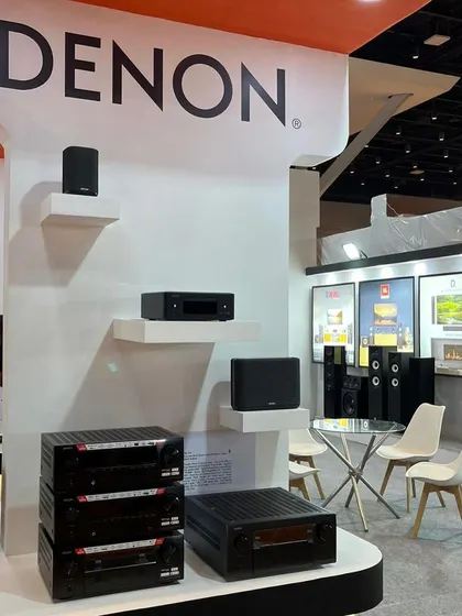 The Denon display at our booth, featuring a range of AV amplifiers and speakers. We are proud to be a premium partner for world-class audio brands at major industry events.