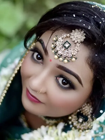 This artistic shot from above highlights the intricate details of the maang tikka and the perfectly blended eye makeup. It’s a modern take on a classic bridal portrait.
