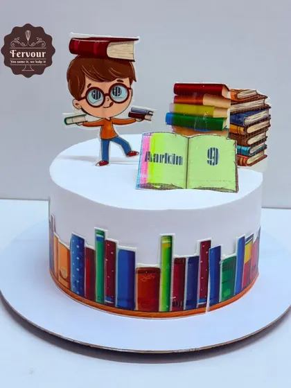 A book-themed cake for a 9-year-old reader. The design features edible book spines around the base and cute toppers of a boy with books.