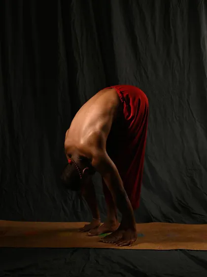 A modified Uttanasana (Standing Forward Bend) with bent knees. For those with tight hamstrings, bending the knees is crucial to allow the spine to lengthen fully, which is the primary goal of the pose.