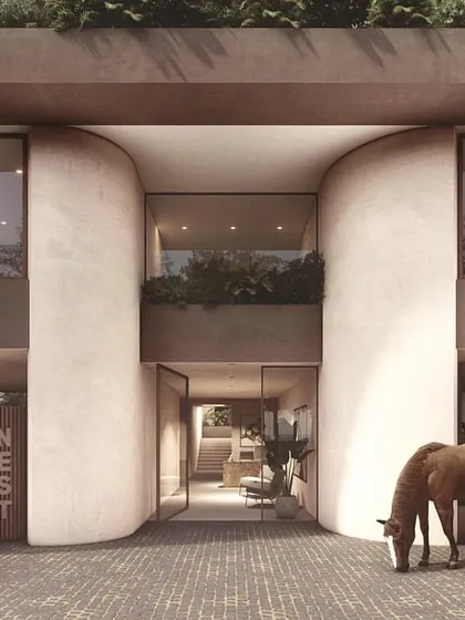 The entrance to The Nest is carved from two large, curved volumes. This creates a dramatic and welcoming gesture, drawing people into the building's lobby and offering a glimpse of the green spaces within.