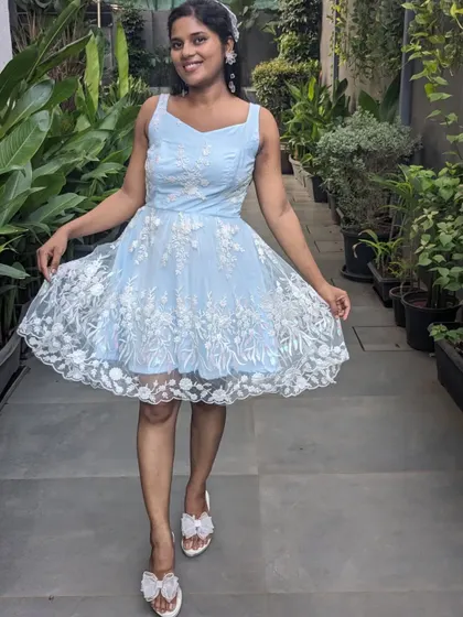 A cute and breezy mini frock in light blue with white floral embroidery. This is a perfect outfit for a summer party, a brunch, or a casual day out.