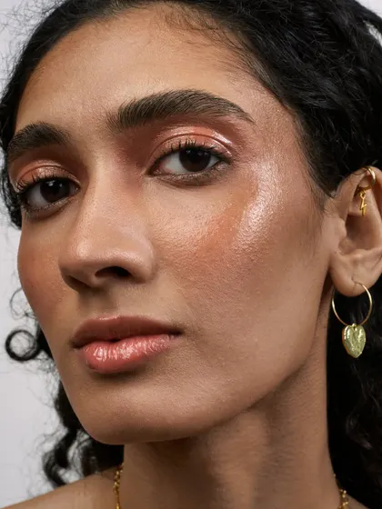 A close-up beauty shot highlighting the glossy, dewy makeup look. This type of image is perfect for showcasing makeup artistry or skincare products.