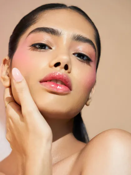 The glossy lips and dewy cheeks create a look that is both simple and incredibly beautiful.
