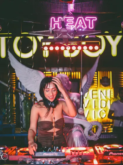 All smiles under the neon lights at Toyboy. The energy and decor of this place are unmatched.