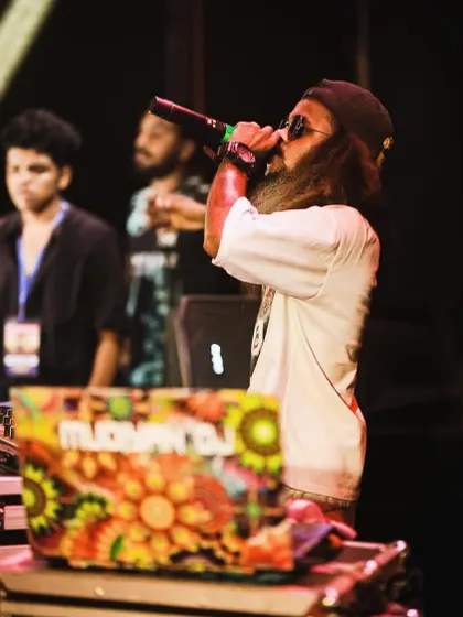 A side profile of me on the mic, with my custom-designed laptop visible.