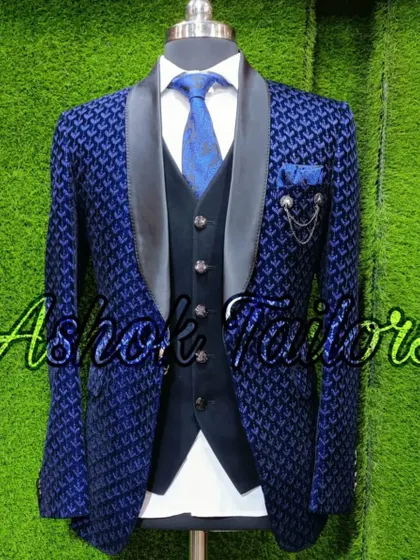 A navy blue tuxedo with a modern, geometric patterned fabric.