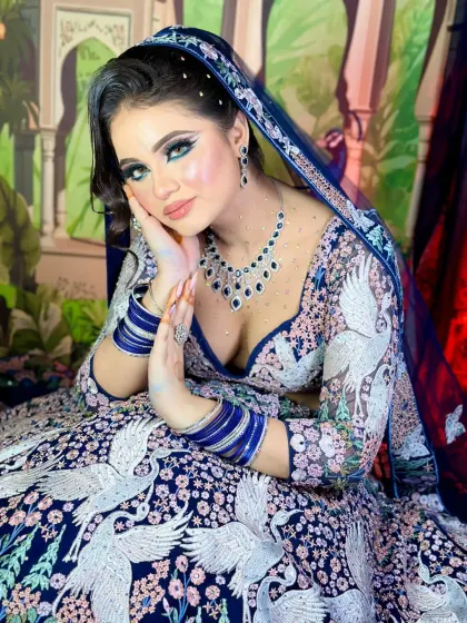 A powerful and confident pose. The makeup is bold and striking, designed to make a statement.