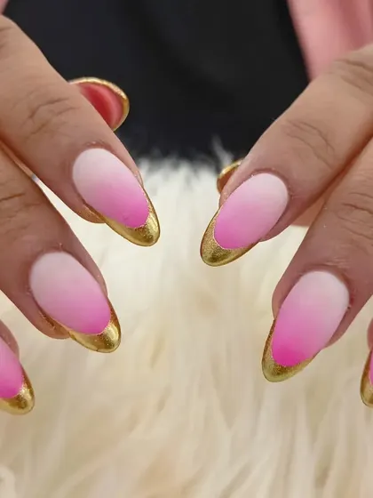 A stunning pink ombré with a matte finish, elevated by a bold gold chrome French tip.