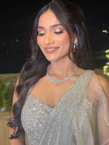 Another beautiful shot of the bride with her eyes closed, highlighting the soft glam makeup and the elegant flow of her hair.