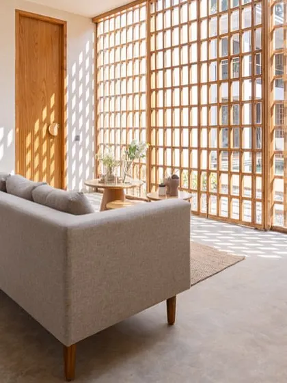 In the House of Basho, we carved an indoor courtyard within the living space. A large skylight and a wall of perforated wooden screens bring in light and shadows that move throughout the day, creating a slow, contemplative atmosphere.