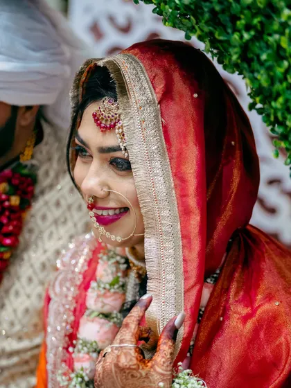 A beautiful profile shot of the bride during the ceremony. The soft light highlights her smile and the traditional details of her Nikah attire.