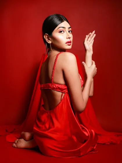 Another angle from our "Elegance in Red" series. This backless satin dress is captured in a way that emphasizes its texture and flow, creating a sense of intimate grace.