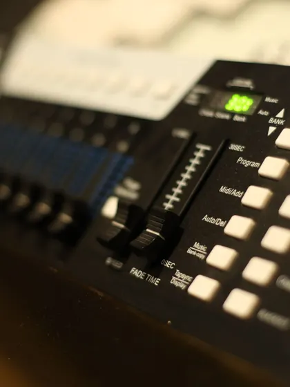 A macro shot of a lighting control board, highlighting the technical details that go into creating the perfect party atmosphere.